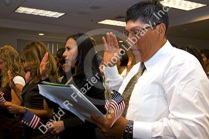 New United States citizens raise their right hand for citizenship oath ceremony in Idaho, USA.