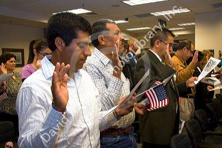 New United States citizens raise their right hand for citizenship oath ceremony in Idaho, USA.