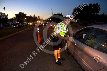 Police officer stopping vehilces in search of a missing child in Boise, Idaho, USA.