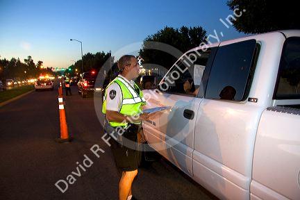 Police officer stopping vehilces in search of a missing child in Boise, Idaho, USA.