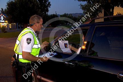 Police officer stopping vehilces in search of a missing child in Boise, Idaho, USA.