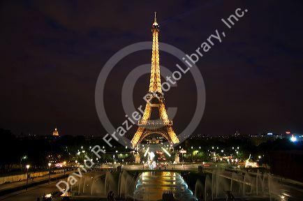The Eiffel Tower lit up at night located on the Champ de Mars in Paris, France.