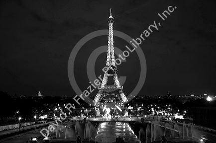 The Eiffel Tower lit up at night located on the Champ de Mars in Paris, France.