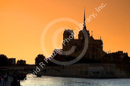 Nortre Dame cathedral and the River Seine at sunset in Paris, France.