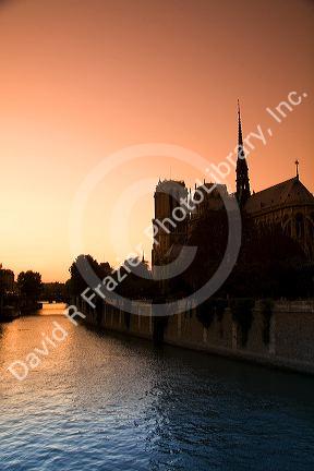 Nortre Dame cathedral and the River Seine at sunset in Paris, France.