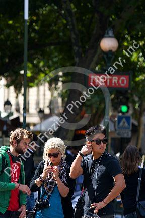 Students near the Metro entrance at Place Saint-Michel in Paris, France.