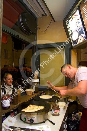 French man making crepes at a Creperie in the Montmartre District of Paris, France.