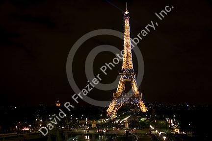 The Eiffel Tower lit up at night located on the Champ de Mars in Paris, France.