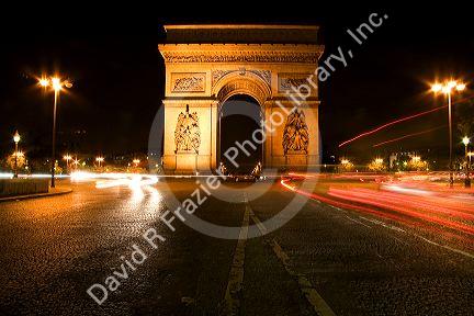 Arc de Triomphe lit at night stands in the centre of the Place Charles de Gaulle, Paris, France.