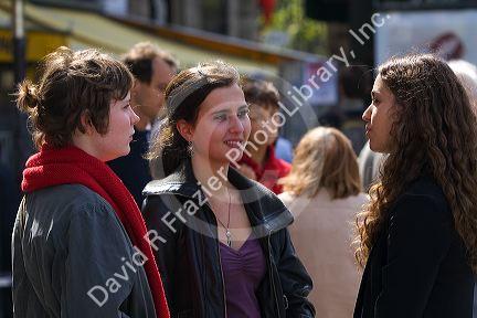 French students socialize in the Place Saint-Michel, Paris, France.