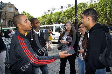 French students socialize in the Place Saint-Michel, Paris, France.