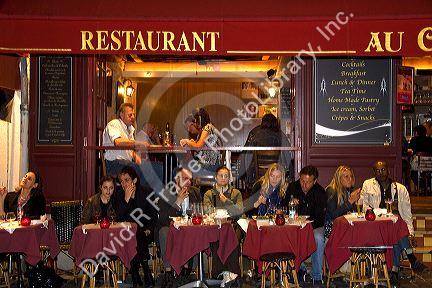 Restaurant exterior and nightlife in the Montmartre District of Paris, France.