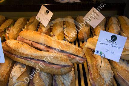 Ham and cheese sandwich in the storefront window of bakeshop in Paris, France.