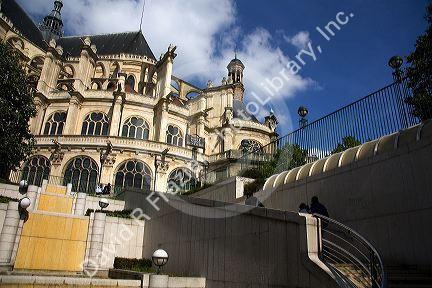 Eglise Saint-Eustache gothic architecture contrasting with the modern staircase of Les Halles in Paris, France.