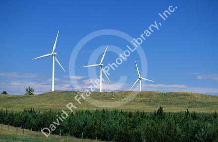 Three white windmills on a hillside in Kimball, Nebraska.