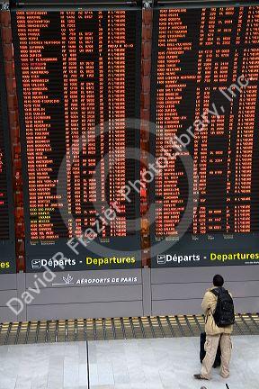 Departure board located in the Paris-Charles de Gaulle Airport, Paris, France.