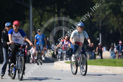 Pedestrians and bicyclists traveling on the Paseo de la Reforma on a Sunday in Mexico City, Mexico.