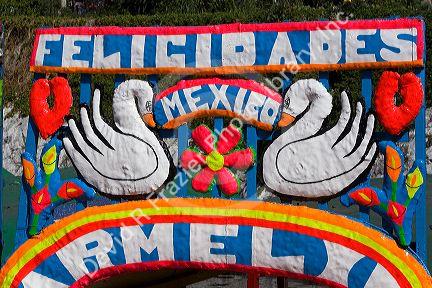 Colorful trajineras travel on the Xochimilco canals within Mexico City, Mexico.