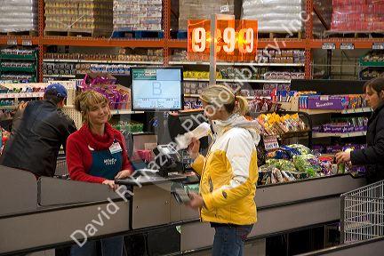 Customer and cashier in the checkout line of a supermarket in Idaho, USA.