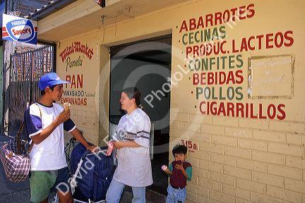 Chilean people eat ice cream in front of a small grocery store in Pelequen, Chile.