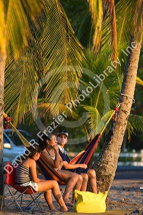 People relaxing in a hammock at Playa Carrillo near Samara, Costa Rica.