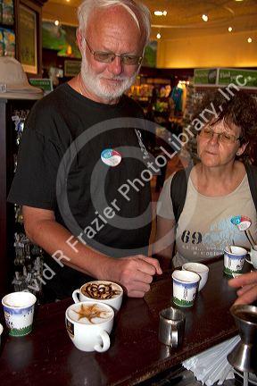 Barista making coffee drinks with tourists at the Britt coffee bar in San Rafael de Heredia, Costa Rica.