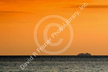 Cruise ship in the pacific ocean at sunset off the coast of Jaco, Costa Rica.