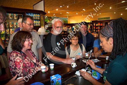 Barista making coffee drinks with tourists at the Britt coffee bar in San Rafael de Heredia, Costa Rica.