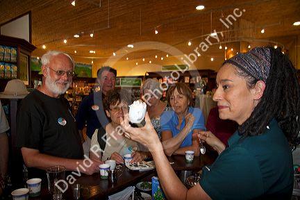 Barista making coffee drinks with tourists at the Britt coffee bar in San Rafael de Heredia, Costa Rica.