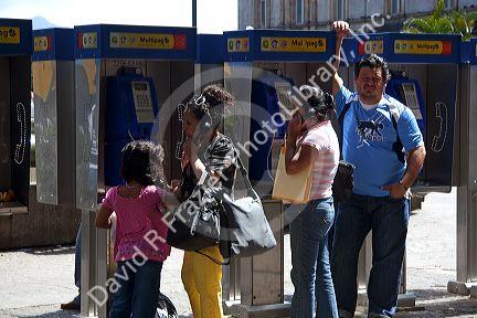 People using pay telephones in the city of San Jose, Costa Rica.