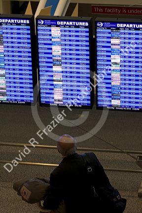 Departure board at the Denver International Airport in Denver, Colorado, USA.