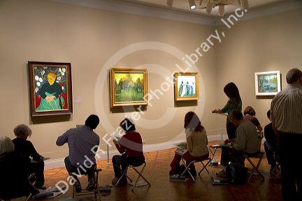 Art students copy paintings displayed at the Art Institute of Chicago, Illinois, USA.