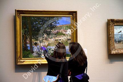 Women admire fine art displayed at the Art Institute of Chicago, Illinois, USA.