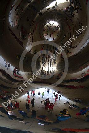 Visitors look at their reflection in the Cloud Gate public sculpture located at the AT&T Plaza in Millennium Park, Chicago, Illinois.