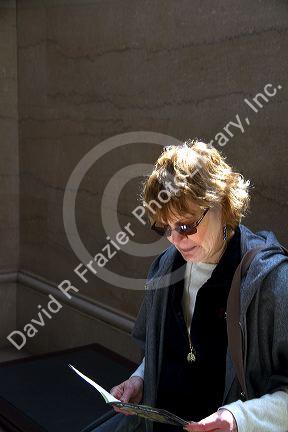 Female tourist at the Art Institute of Chicago, Illinois, USA. MR