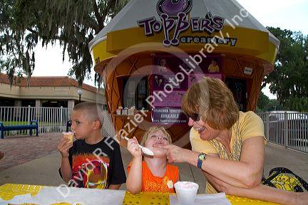 Grandmother with grand children eating ice cream in Brandon, Florida, USA. MR