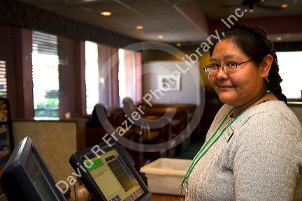 Navajo woman working as a restaurant hostess in Farmington, New Mexico, USA.