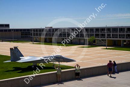 F-15 aircraft on display in the Terrazzo with dormitories in the background at the Air Force Academy in Colorado Springs, Colorado, USA.