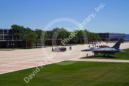 F-16 aircraft on display in the Terrazzo with dormitories in the background at the Air Force Academy in Colorado Springs, Colorado, USA.