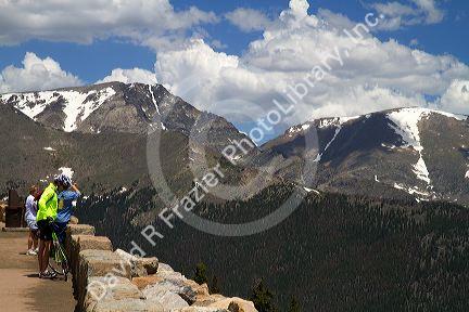 Tourists view the Rocky Mountains from a scenic overlook in the Rocky Mountain National Park, Colorado, USA.