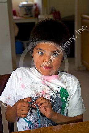 Native Pueblo boy crafting dreamcatchers in San Felipe Pueblo, New Mexico, USA.