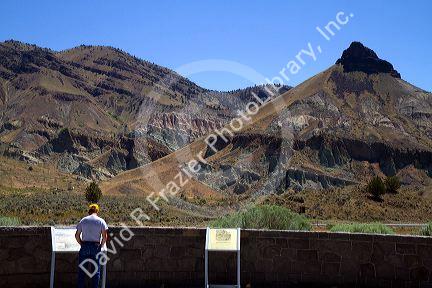 Tourist at the Condon Visitor Center overlooking Sheep Rock at the John Day Fossil Beds National Monument in Eastern Oregon, USA.