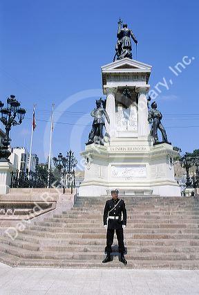A guard standing in front of a military monument in Valparaiso, Chile.