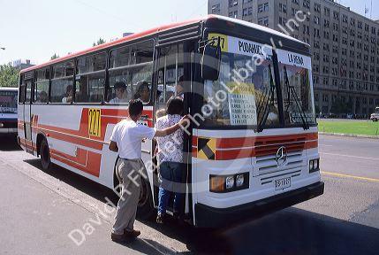 People boarding a bus in Santiago, Chile.
