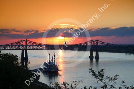 Sunset with steamboat under the Natchez-Vidalia Bridges spanning the Mississippi River between Vidalia, Louisiana and Natchez, Mississippi, USA.