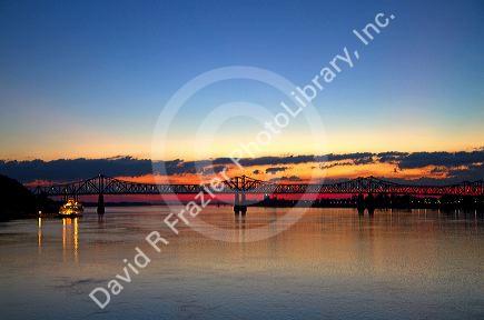 Sunset with steamboat under the Natchez-Vidalia Bridges spanning the Mississippi River between Vidalia, Louisiana and Natchez, Mississippi, USA.