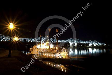 Steamboat docked at night near the Natchez-Vidalia Bridges spanning the Mississippi River between Vidalia, Louisiana and Natchez, Mississippi, USA.