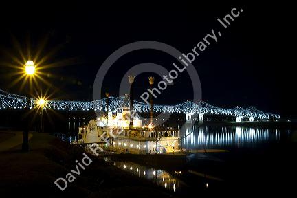 Steamboat docked at night near the Natchez-Vidalia Bridges spanning the Mississippi River between Vidalia, Louisiana and Natchez, Mississippi, USA.