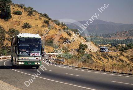 A bus traveling on the highway in rural Chile.