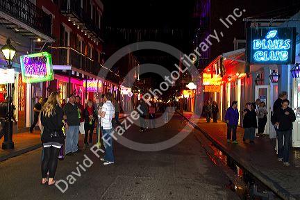 Neon signs of bars and restaurants along Bourbon Street in the French Quarter of New Orleans, Louisiana, USA.